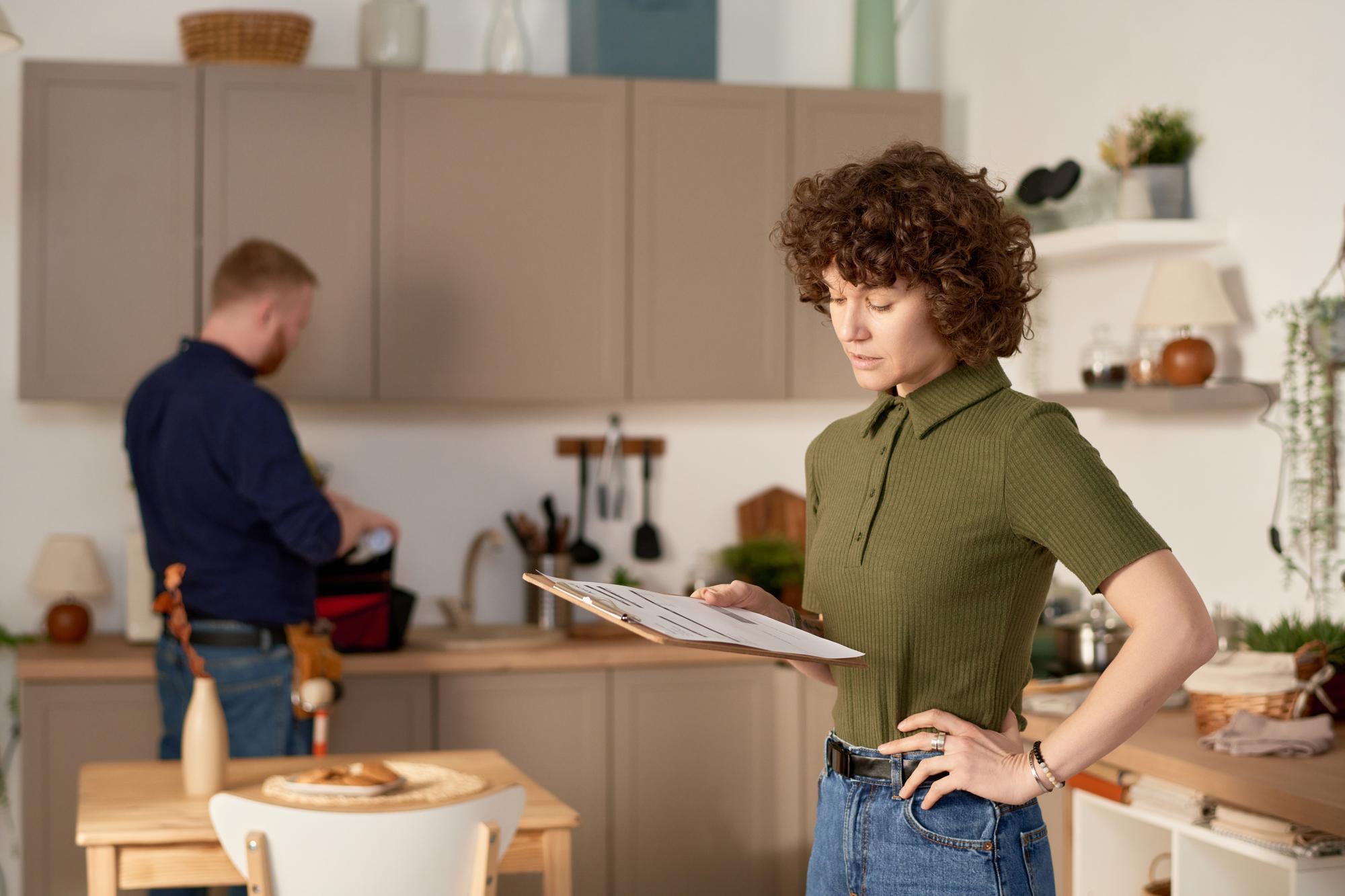 Consultant reviewing kitchen checklist